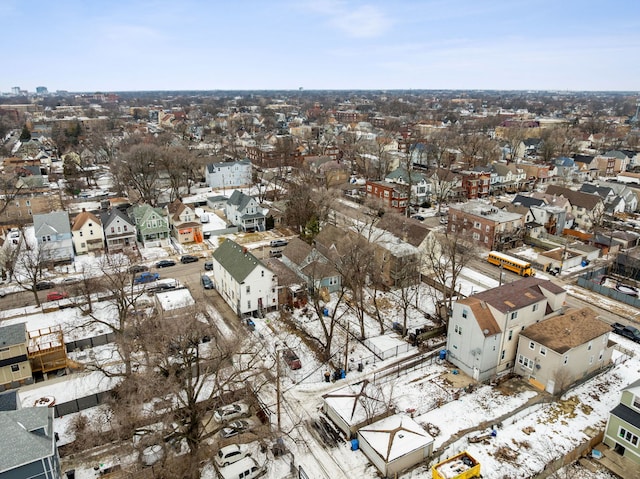 snowy aerial view with a residential view