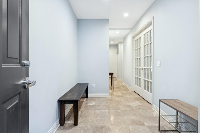 hallway featuring baseboards and recessed lighting