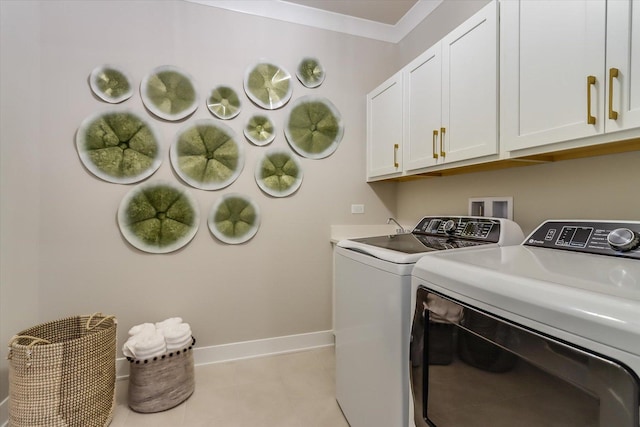 washroom with crown molding, washer and clothes dryer, cabinet space, light tile patterned flooring, and baseboards