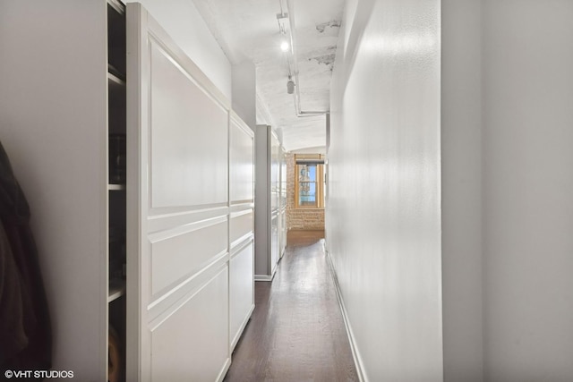 hallway featuring dark wood-style floors and rail lighting