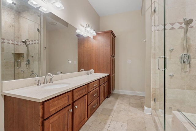 full bath featuring a shower stall, baseboards, and a sink