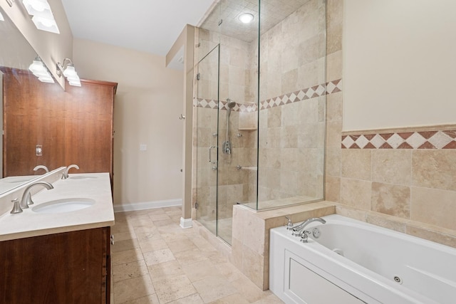 full bath with a stall shower, baseboards, a sink, and a whirlpool tub