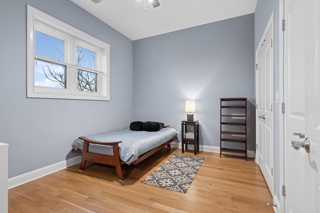 bedroom with baseboards and wood finished floors