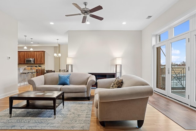 living room featuring ceiling fan, recessed lighting, and light wood-style floors