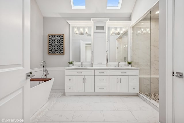 bathroom with marble finish floor, double vanity, a soaking tub, a sink, and tiled shower