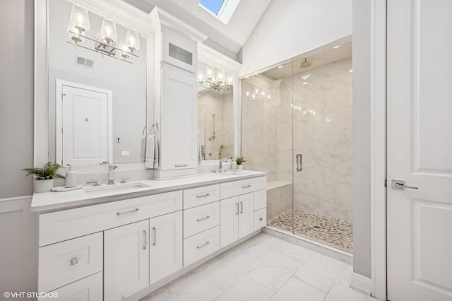 full bathroom featuring vaulted ceiling with skylight, a sink, visible vents, marble finish floor, and a marble finish shower