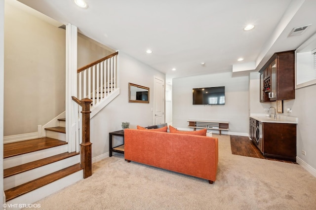 living area with carpet floors, recessed lighting, indoor wet bar, and stairs