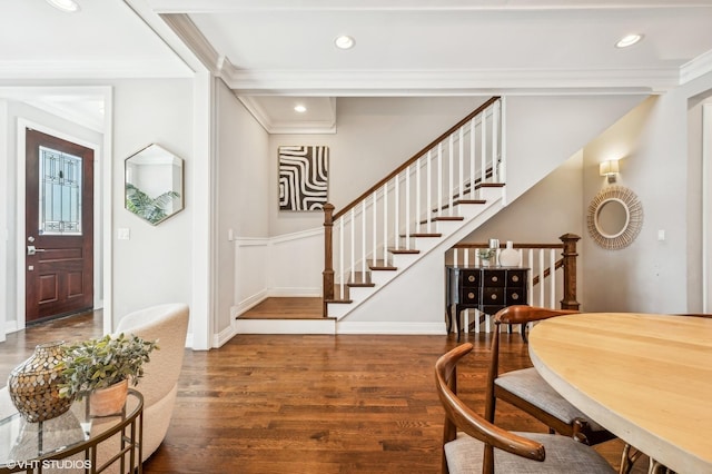 foyer with recessed lighting, wood finished floors, baseboards, stairs, and ornamental molding