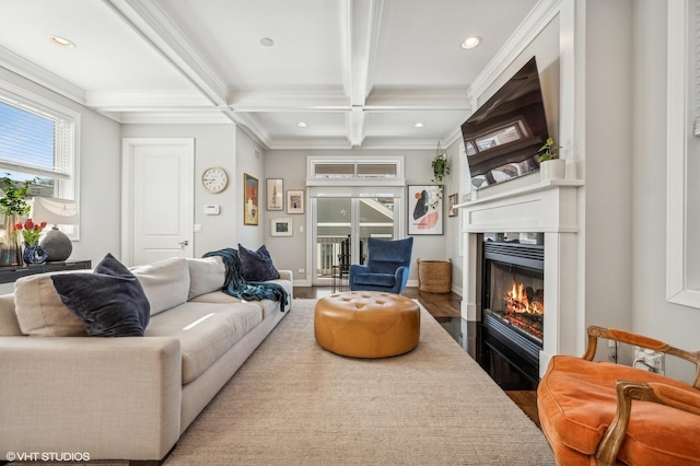 living area with recessed lighting, coffered ceiling, ornamental molding, beamed ceiling, and a glass covered fireplace