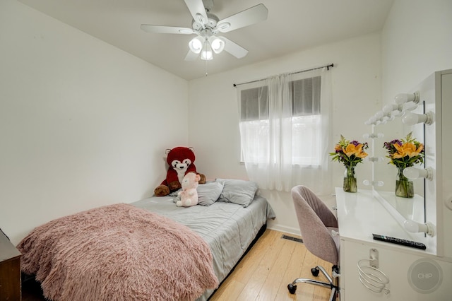 bedroom with a ceiling fan, light wood-type flooring, and visible vents