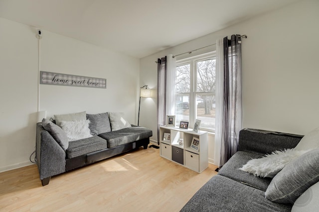 living area featuring light wood-type flooring and baseboards