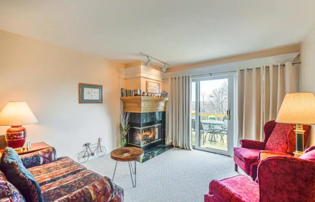 living room with a fireplace, carpet flooring, and track lighting