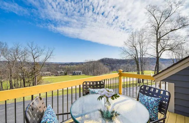 wooden terrace with outdoor dining area