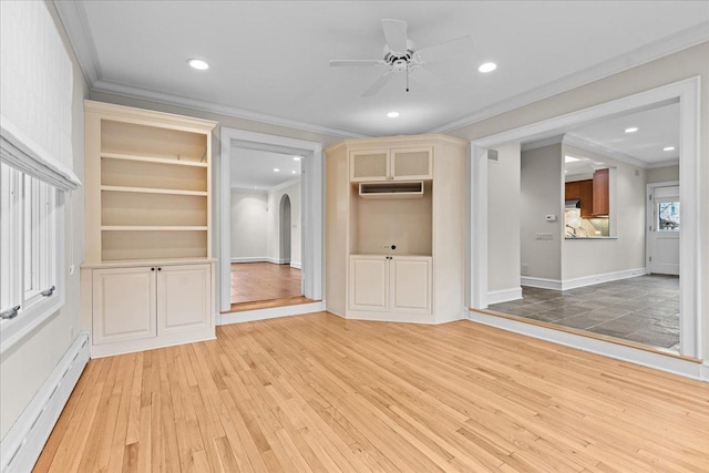 unfurnished living room featuring ceiling fan, arched walkways, light wood-style flooring, a baseboard heating unit, and crown molding