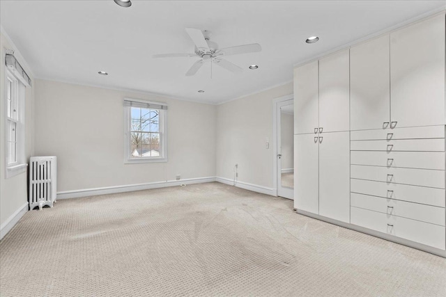 unfurnished bedroom featuring baseboards, radiator heating unit, recessed lighting, and light colored carpet