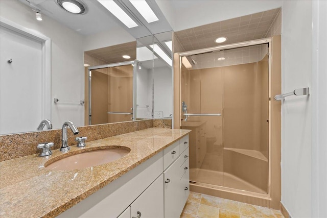 full bathroom with a shower stall, tile patterned flooring, and vanity