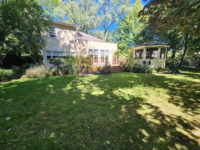 view of yard featuring a deck and an outdoor structure