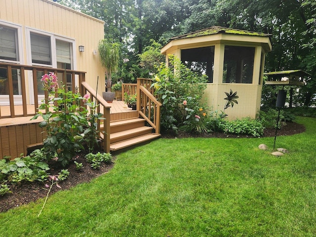 view of yard featuring an outdoor structure, a wooden deck, and a storage unit