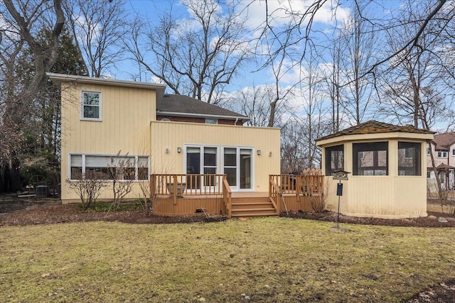 rear view of house with a deck, a yard, and central AC unit