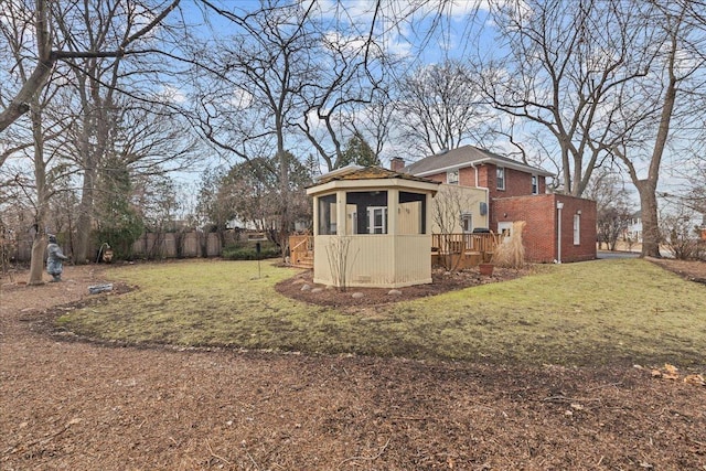 view of yard with a deck and fence