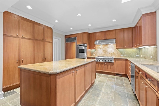 kitchen featuring tasteful backsplash, light stone counters, a center island, stainless steel appliances, and under cabinet range hood