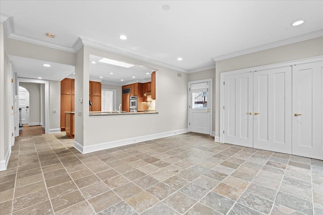 foyer entrance with stone finish floor, recessed lighting, baseboards, and ornamental molding