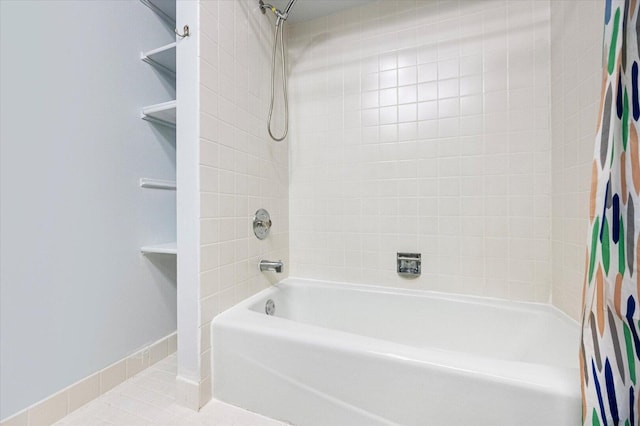 full bathroom with shower / tub combo, baseboards, and tile patterned floors