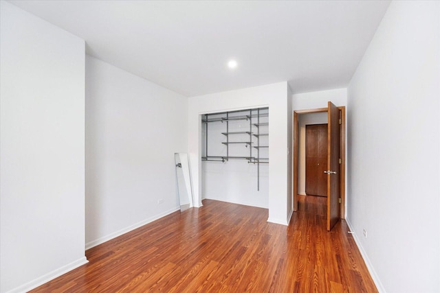 unfurnished bedroom featuring baseboards and wood finished floors