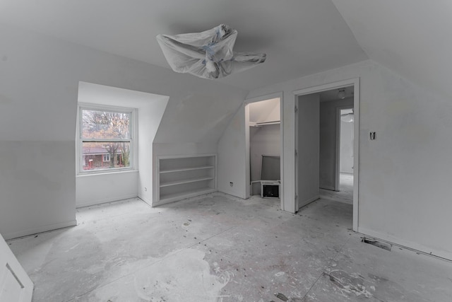 additional living space with lofted ceiling and built in shelves