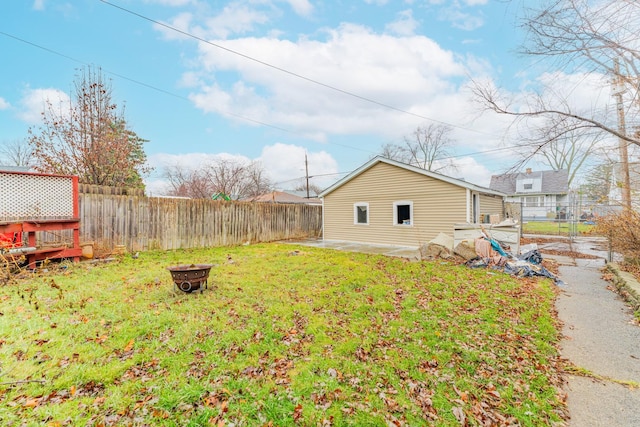 view of yard with an outdoor fire pit, a fenced backyard, and a patio