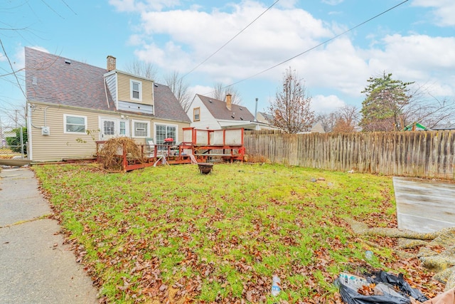 view of yard with fence and a wooden deck