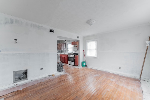 unfurnished living room featuring visible vents and light wood-style floors