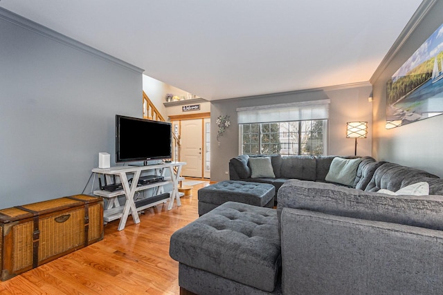 living area with ornamental molding and wood finished floors