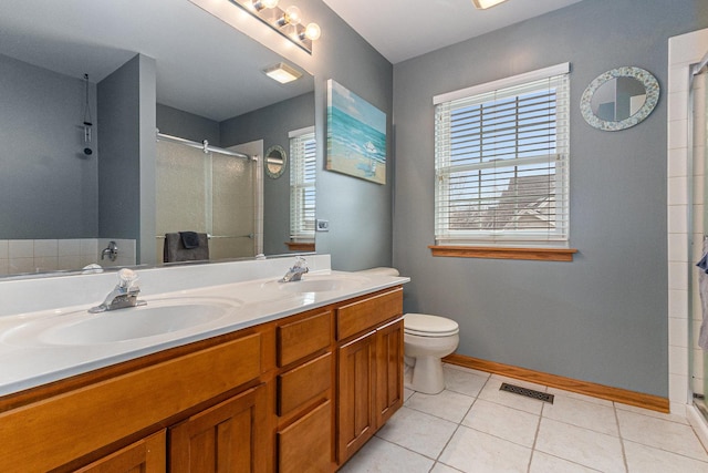 full bath featuring a stall shower, tile patterned flooring, a sink, and visible vents