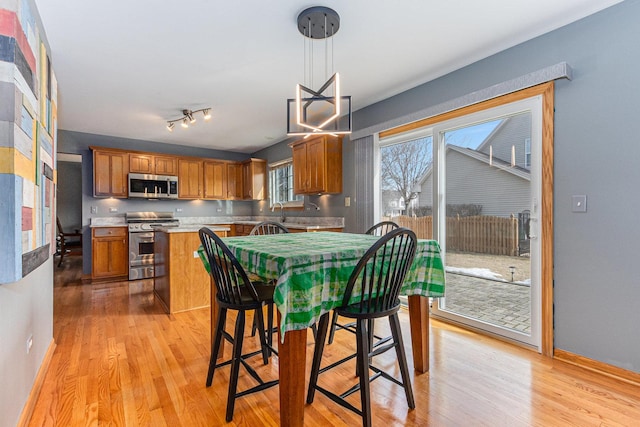 dining room with light wood finished floors and baseboards