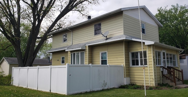 exterior space featuring entry steps and fence