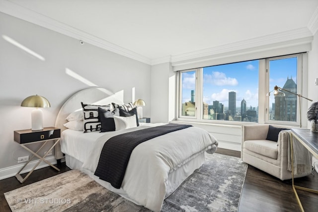 bedroom with dark wood-style floors, a city view, and ornamental molding