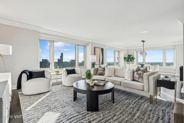 living area featuring a view of city, dark wood-style flooring, a notable chandelier, crown molding, and baseboards