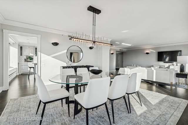 dining space featuring dark wood-type flooring and crown molding