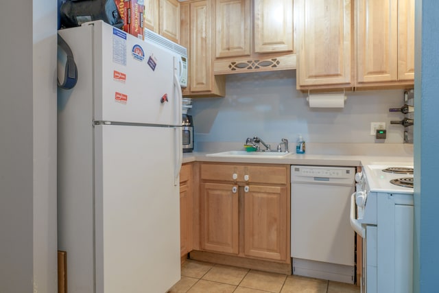 kitchen featuring white appliances, light countertops, a sink, and light tile patterned flooring