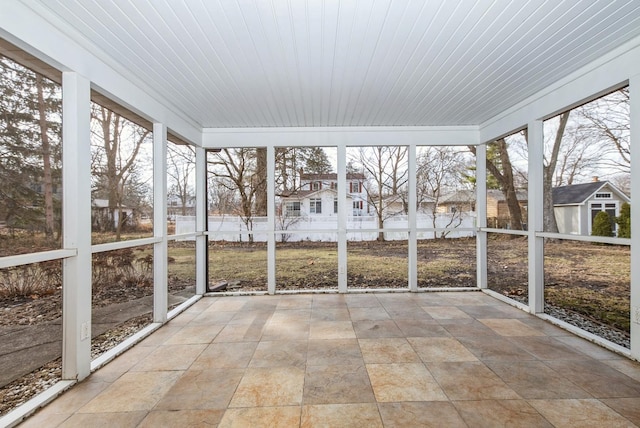 unfurnished sunroom with wooden ceiling