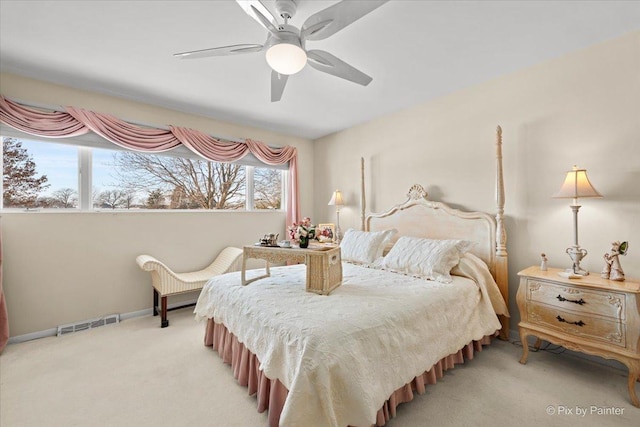 carpeted bedroom featuring visible vents, ceiling fan, and baseboards