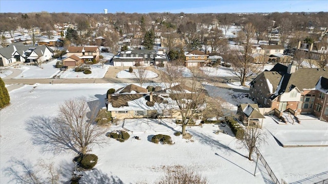 snowy aerial view with a residential view