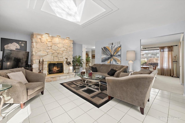 living area with a stone fireplace and light tile patterned floors