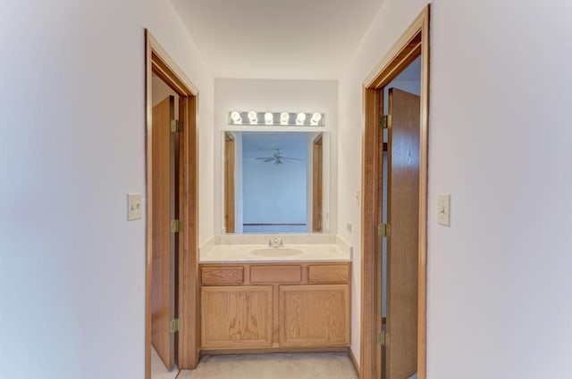 corridor with a sink and light colored carpet