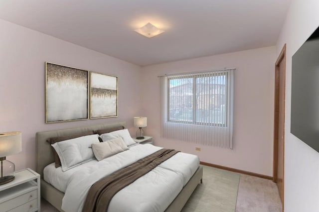 bedroom featuring baseboards and light carpet