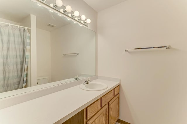 full bath with visible vents, toilet, and vanity