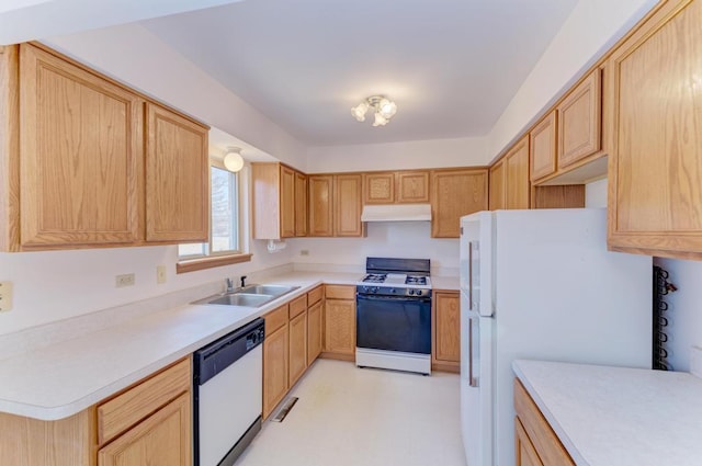 kitchen with light brown cabinets, under cabinet range hood, a sink, white appliances, and light countertops