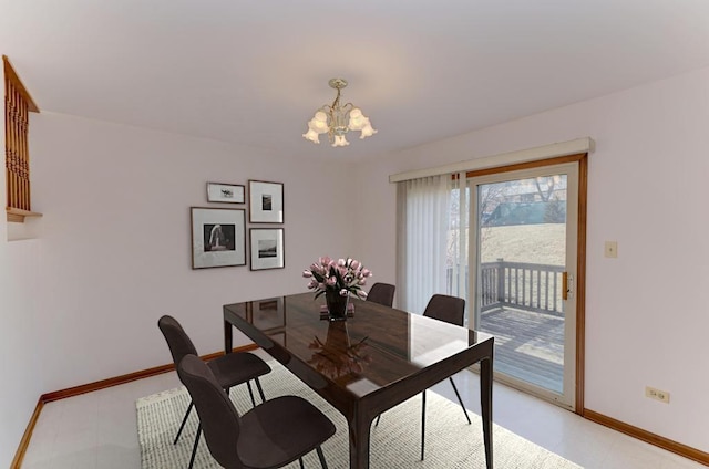 dining room with baseboards, light floors, and a chandelier