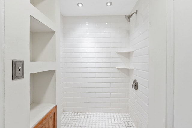 bathroom with recessed lighting and tiled shower